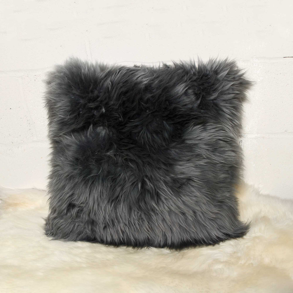 Gray fluffy pillow on a light background