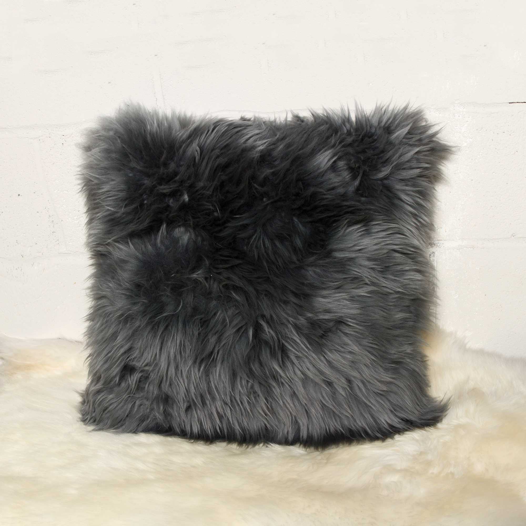 Gray fluffy pillow on a light background