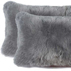 Two gray fluffy pillows on a white background