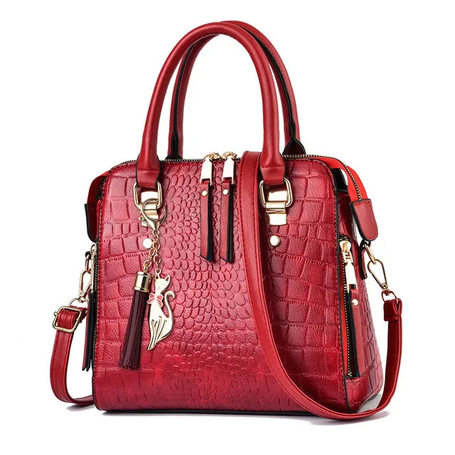 Red handbag with gold accents on a white background